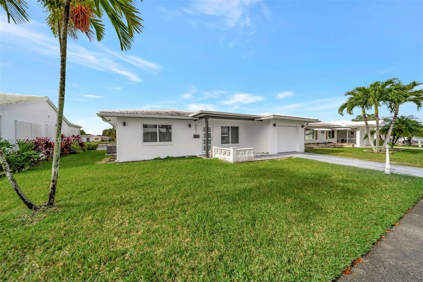 Front exterior — fully renovated with new roof, paint, and impact windows.