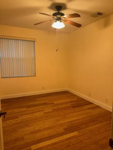 BEDROOM WITH WOOD FLOORS