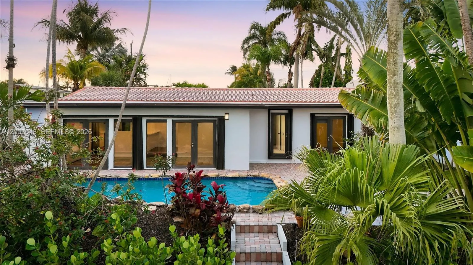 Waterfront Pool Home | Accordion Doors | Tropical Backyard | South Florida