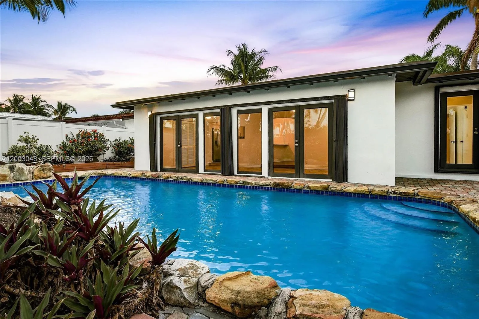 Waterfront Pool Home | Accordion Doors | Tropical Backyard | South Florida