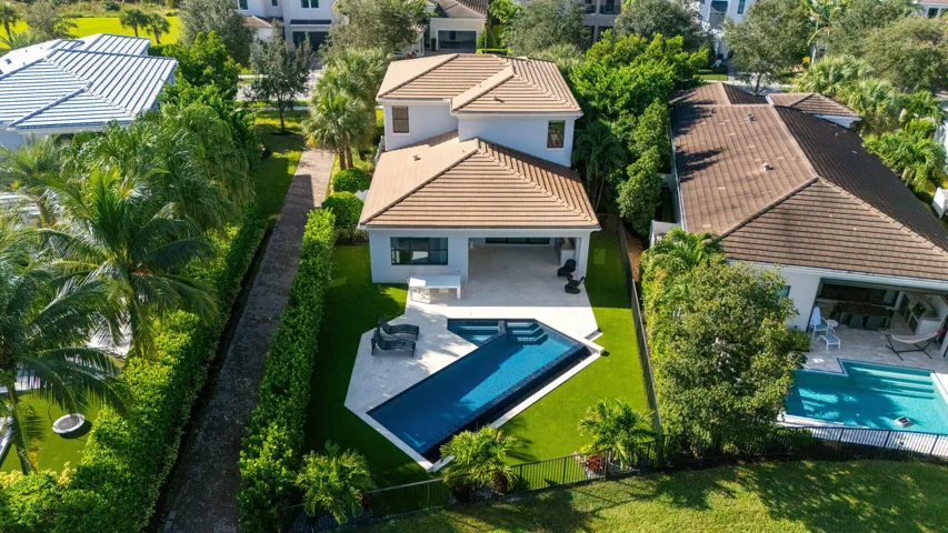 Spacious backyard with artificial turf for care free maintenance.