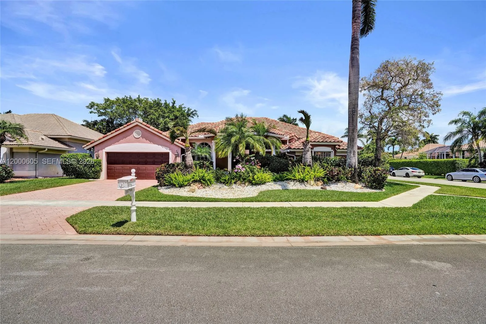 PERFECTLY MANICURED! WITH EXPENSIVE LANDSCAPING! LOTS OF ORCHIDS TOO!