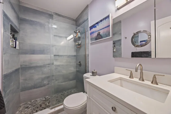 Combo/tub shower removed and updated to a modern step in shower w/updated vanity