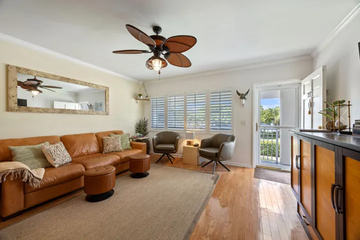 Light & bright living room, with plantation shutters & hardwood flooring