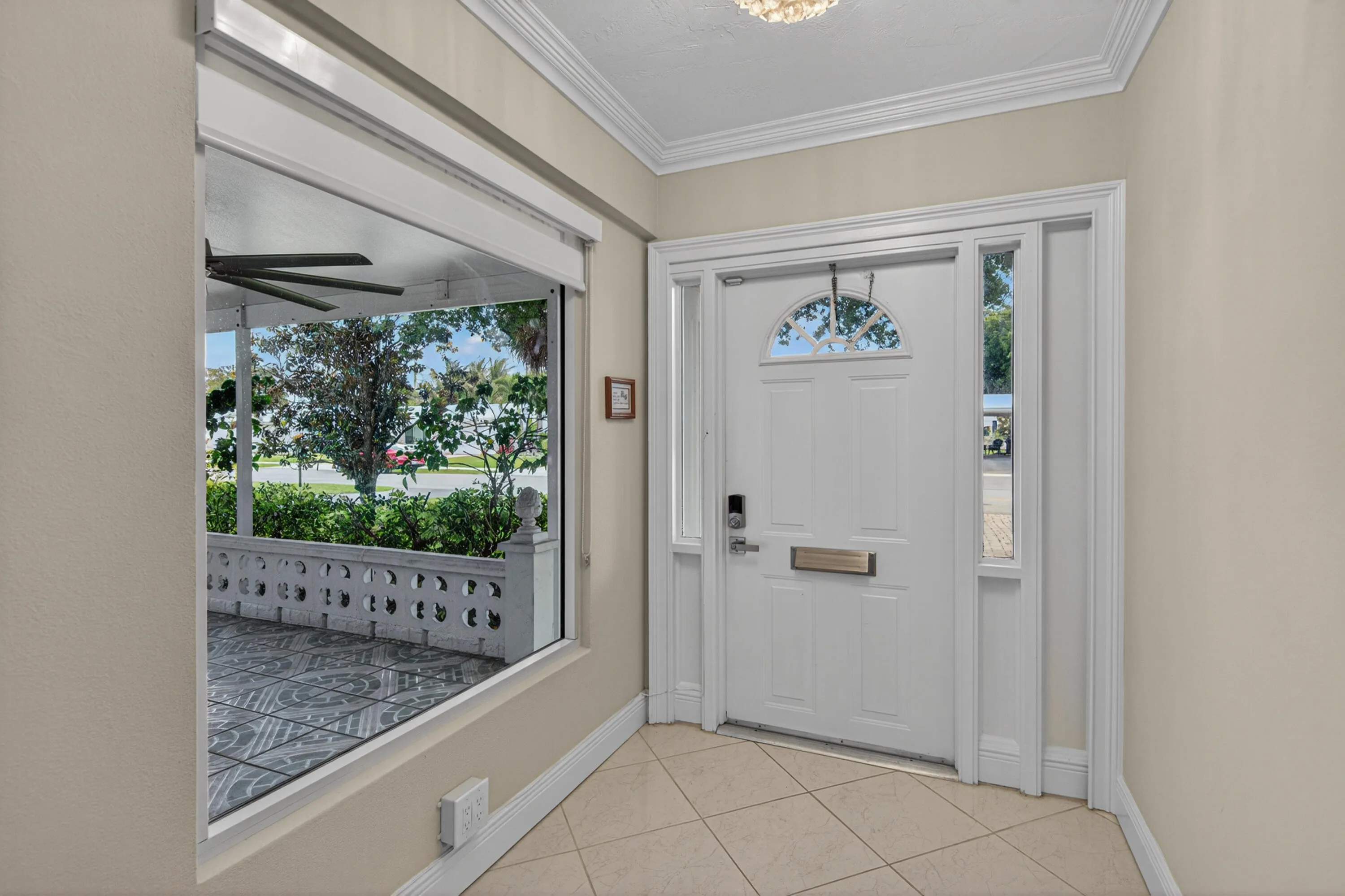 Beautiful entrance hallway with window looking out to the front porch