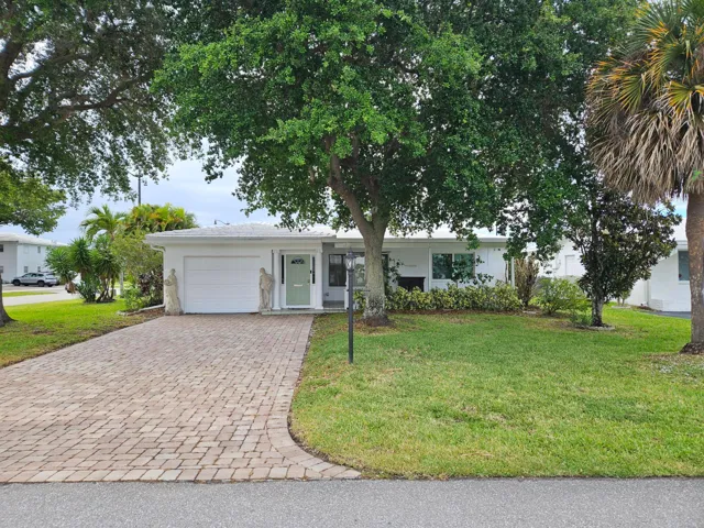 Corner lot with large, covered, front porch and double wide, 4 car paver driveway (2023)
