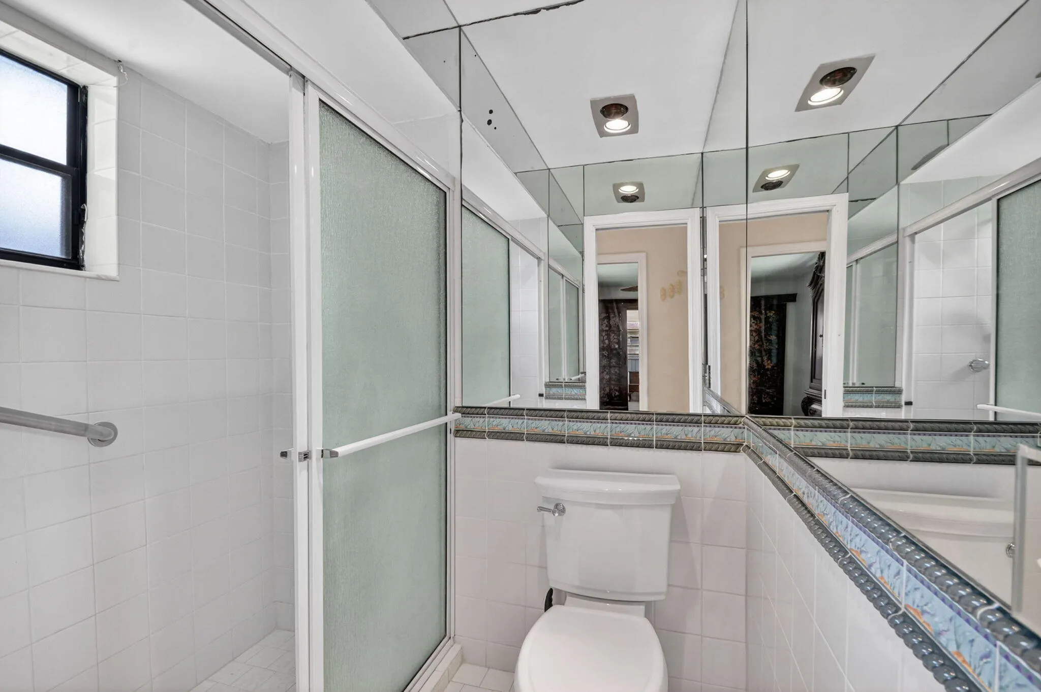 Primary bathroom has a step in shower