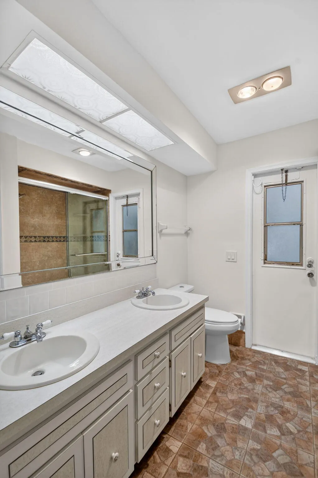 2nd bathroom has double vanity and step in shower