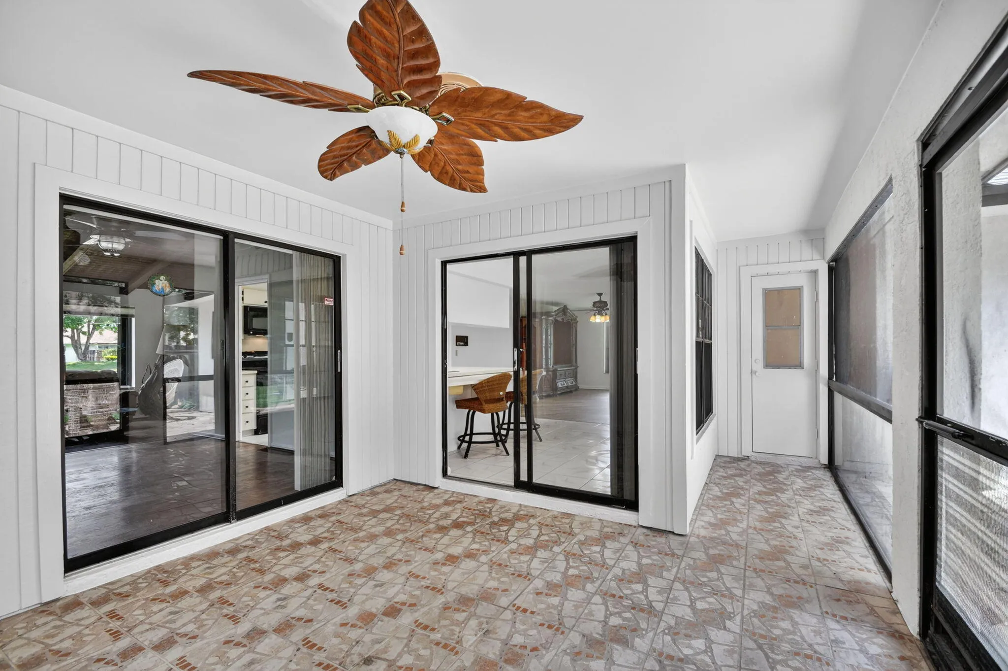 Covered patio leads to extended paver patio and expansive back yard