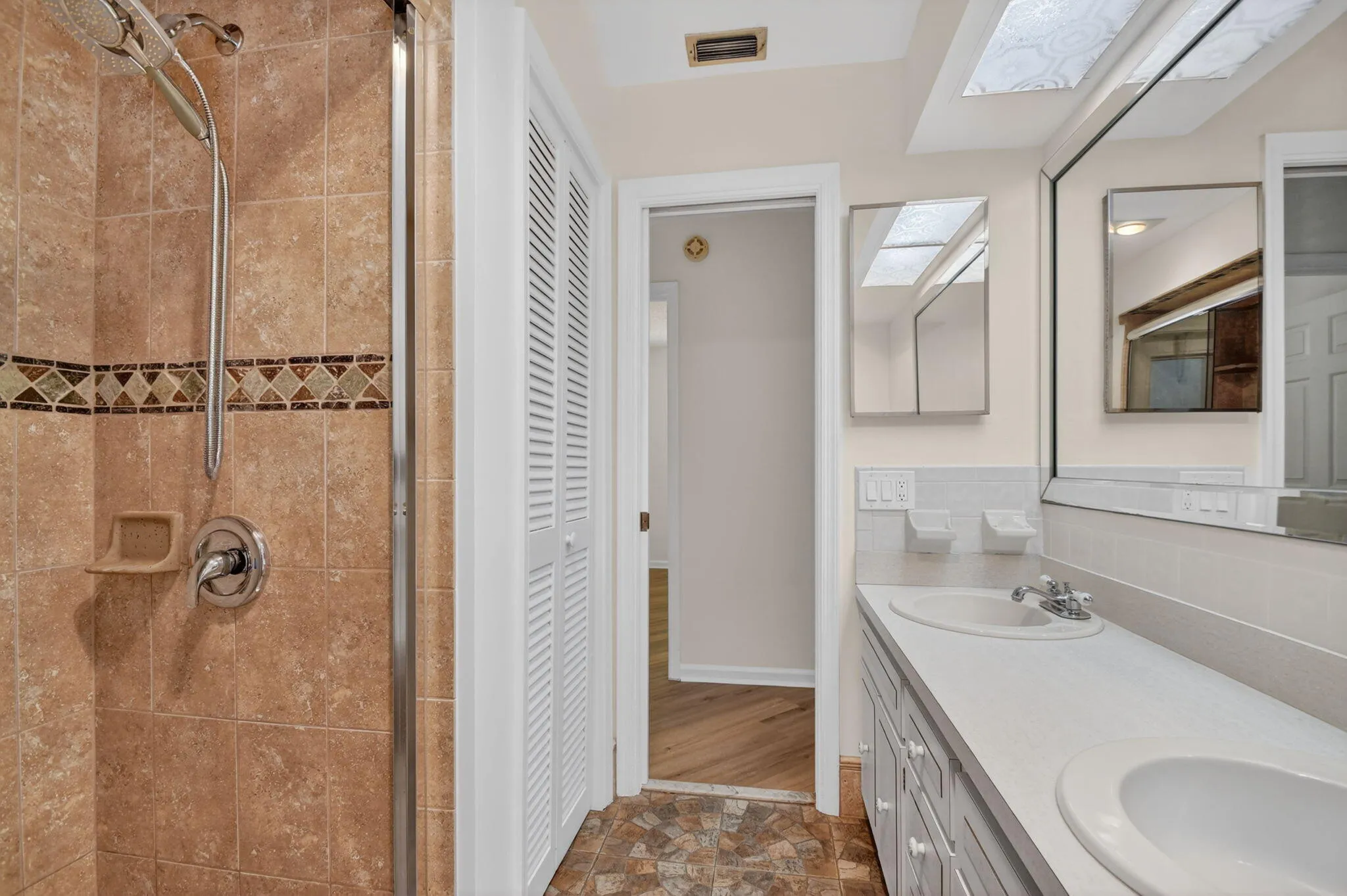 2nd bathroom has double vanity and step in shower