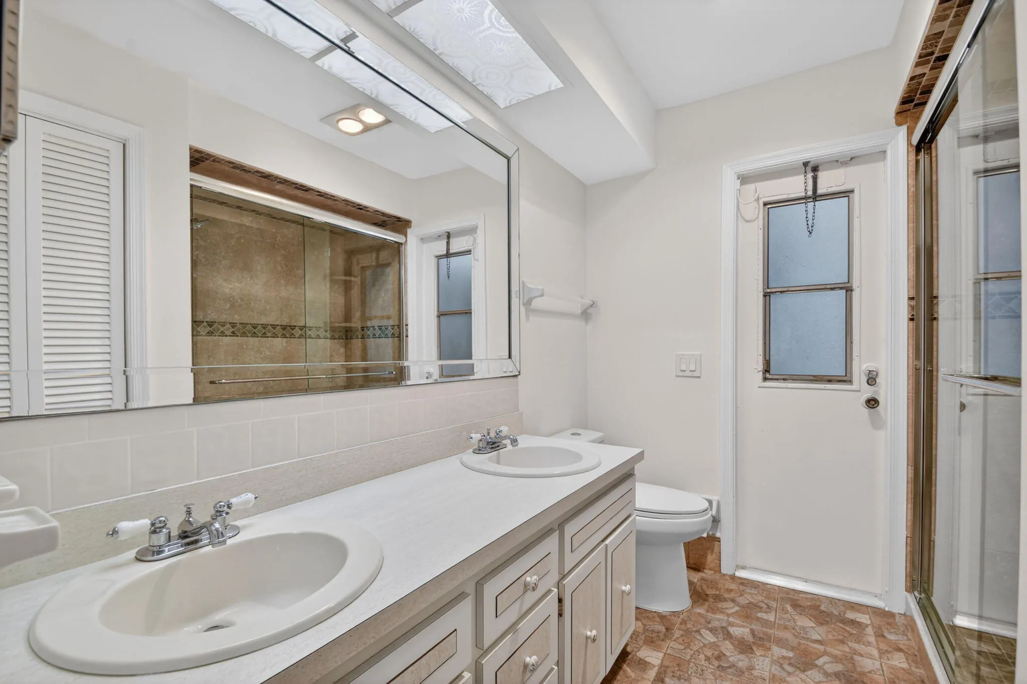 2nd bathroom has double vanity and step in shower