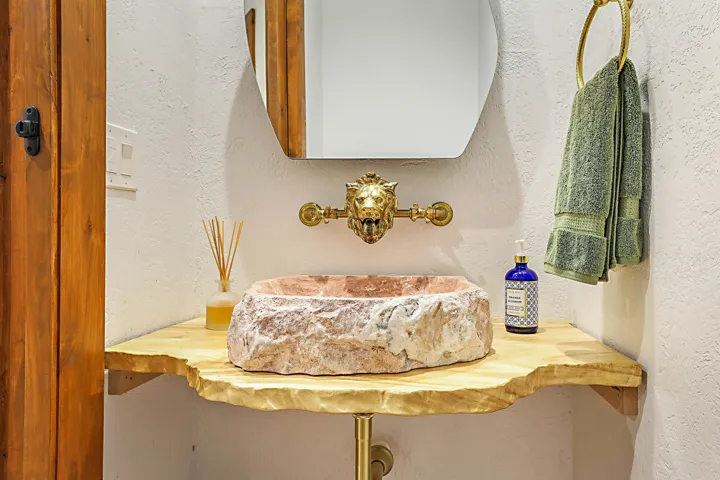 Tumbled marble sink with vintage faucet