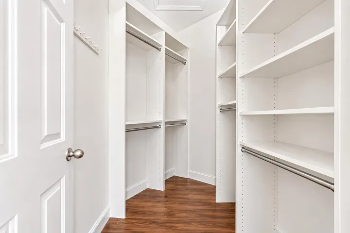 AI Generated. Large walk-in closet off Primary BR sitting room/dressing area.