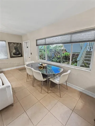 Bright dining area with large windows and modern fixtures — open to the kitchen
