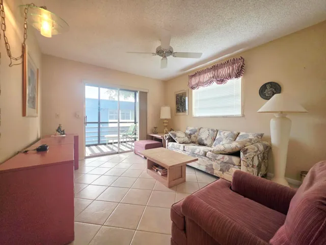 GUEST BEDROOM WITH SLIDING DOORS LEADING TO YOUR SCREENED IN BALCONY
