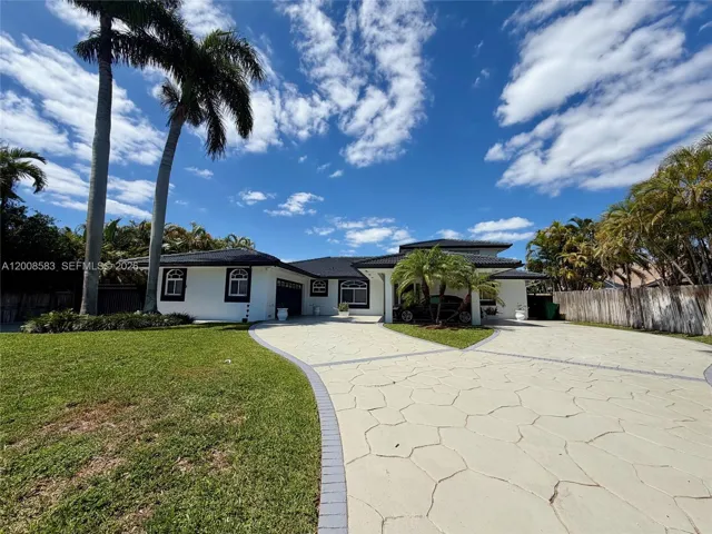 Left side of driveway and home