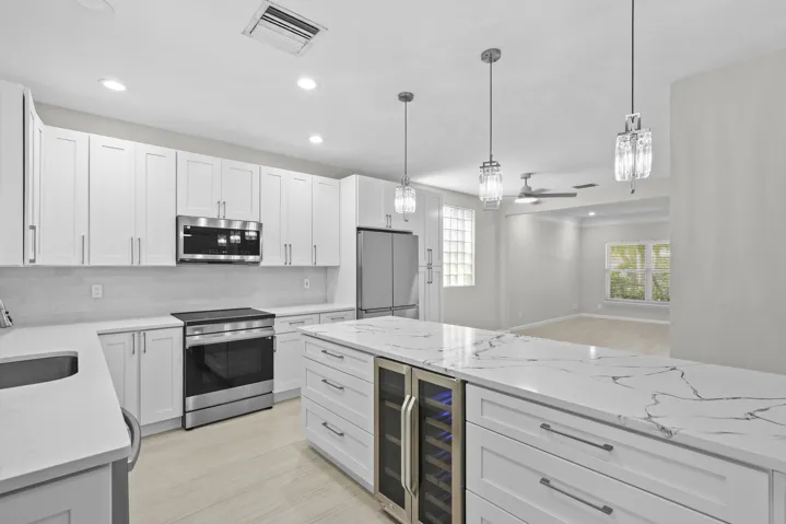 Oversized island bar seating and built-in wine cooler, perfect for entertaining and everyday living.