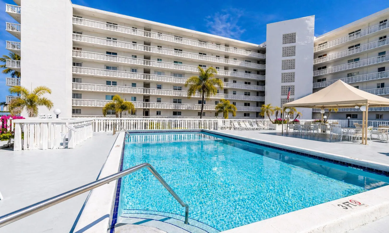 Pool Area – Resort-style pool with expansive sun deck and waterfront setting.
