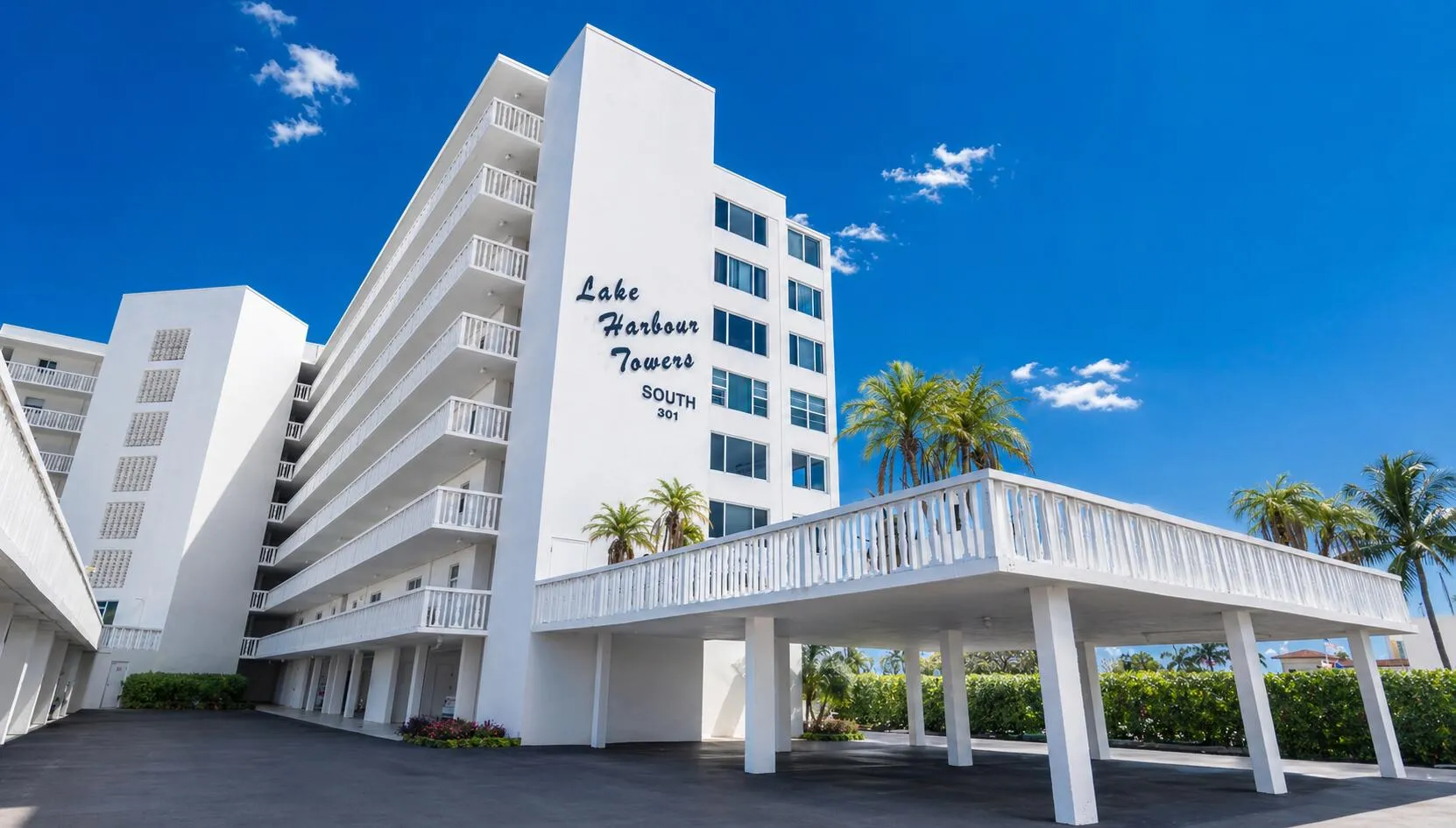 Building Exterior – Well-maintained coastal architecture with covered parking.