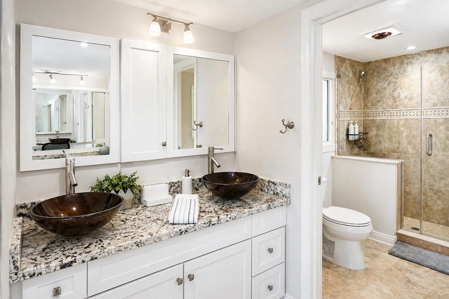 Primary Bathroom – Double vessel sinks with updated vanity and modern fixtures.