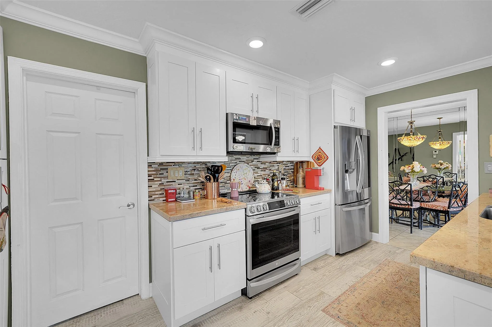 Great kitchen with custom granite and high end "smart" appliances. Crown molding all around, laundry room behind the door
