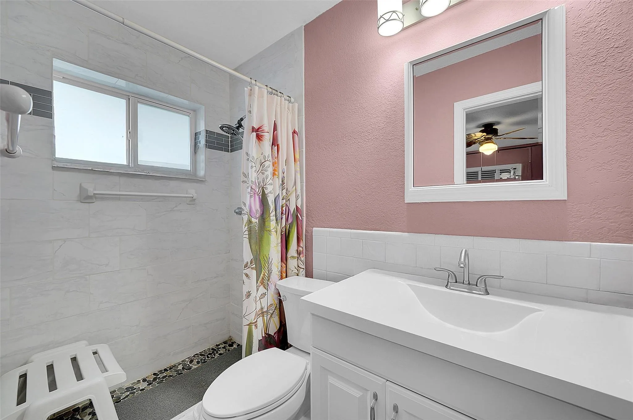 Primary bath with tiled shower and large vanity