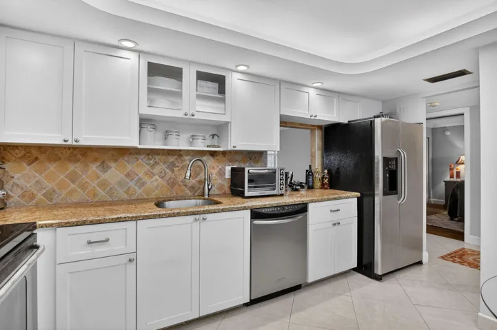 SS Appliances, White wood cabinetry, sleek granite countertops