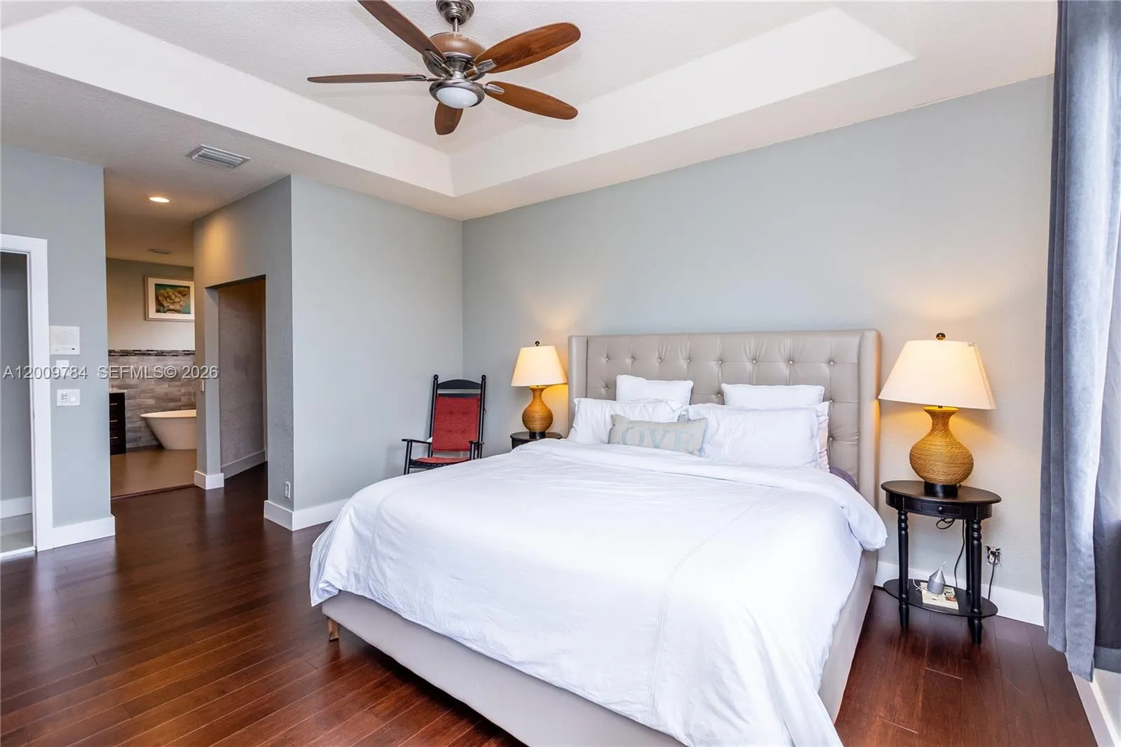 Beautiful 1st floor master bedroom with real wood dark floors and beautiful view of the lake.