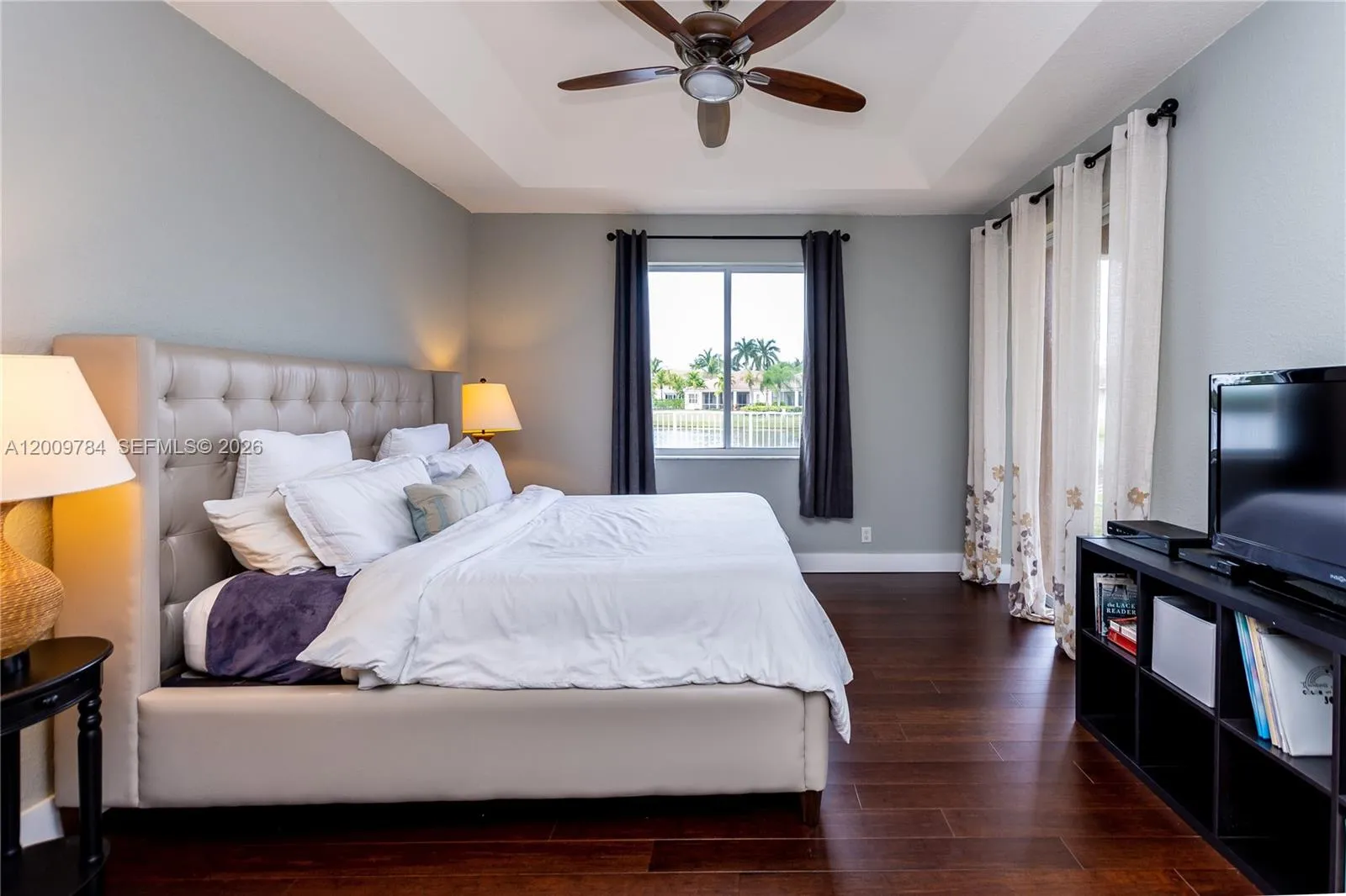 Beautiful 1st floor master bedroom with real wood dark floors and beautiful view of the lake.