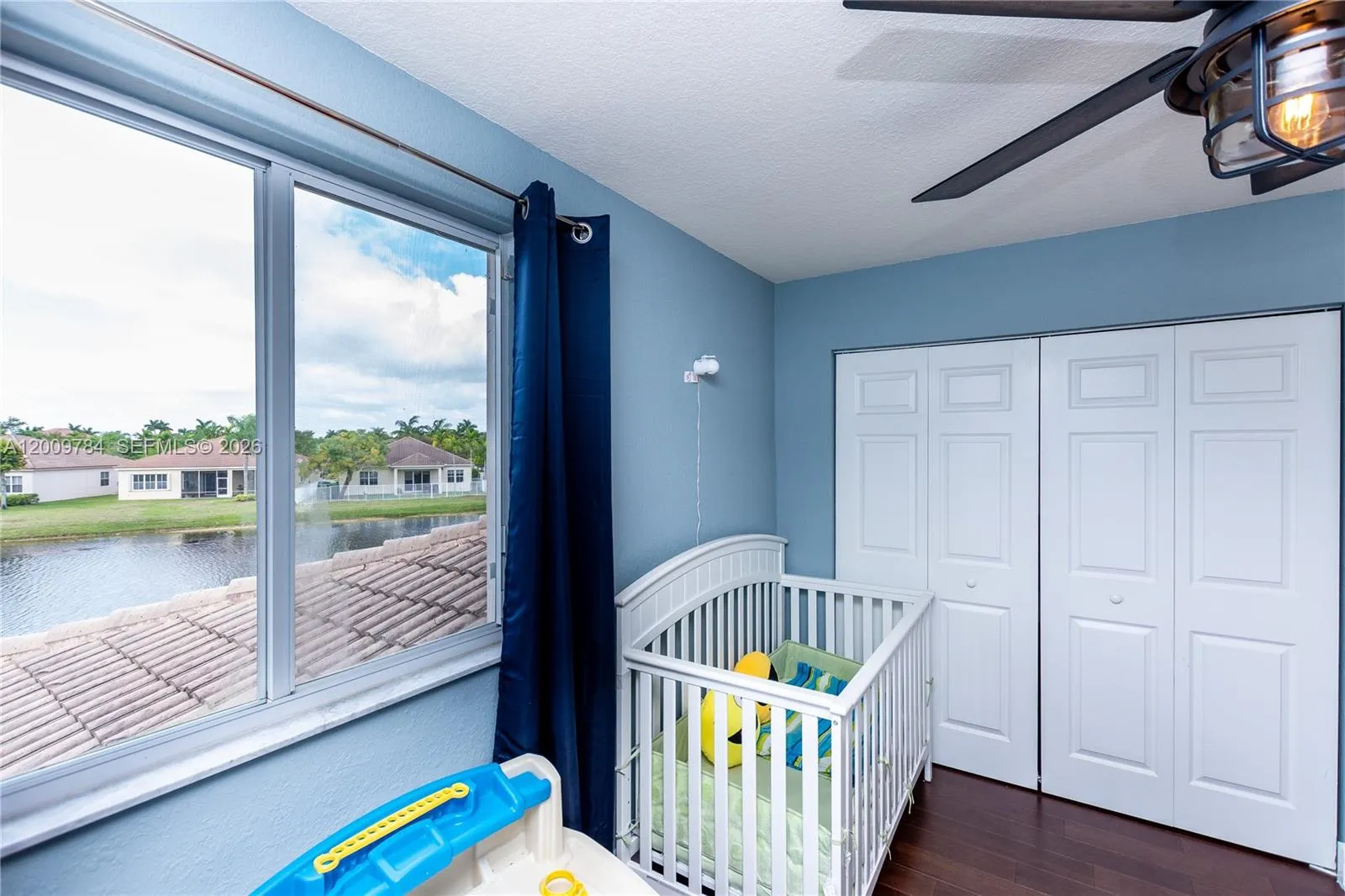 Beautiful 2nd floor corner bedroom with real wood dark floors and lake view