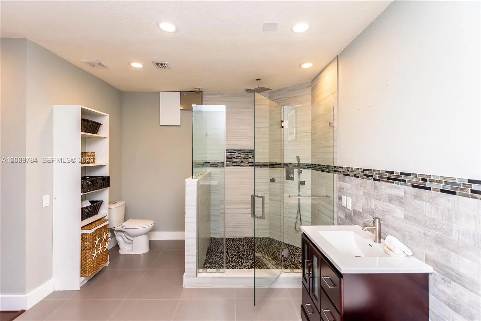Amazing 1st floor master bathroom with free standing tub, his and hers vanities, rain shower, Italian brass nickel accessories.