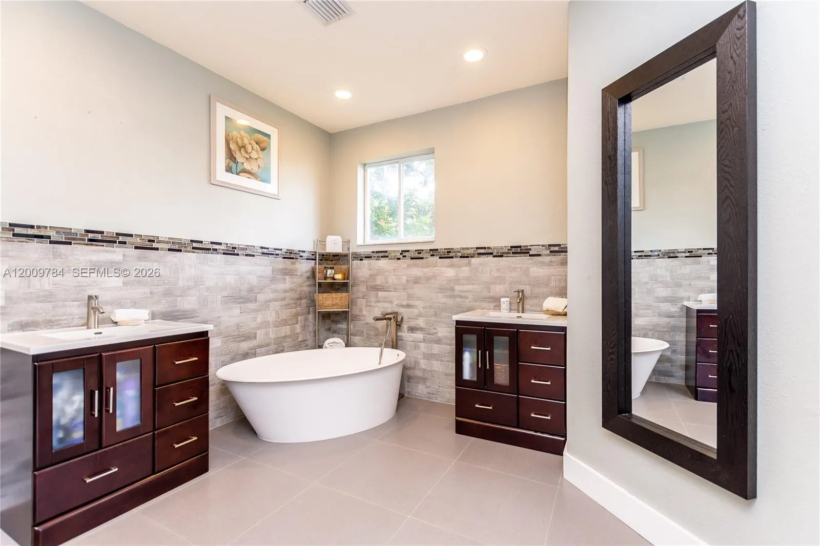 Amazing 1st floor master bathroom with free standing tub, his and hers vanities, rain shower, Italian brass nickel accessories.