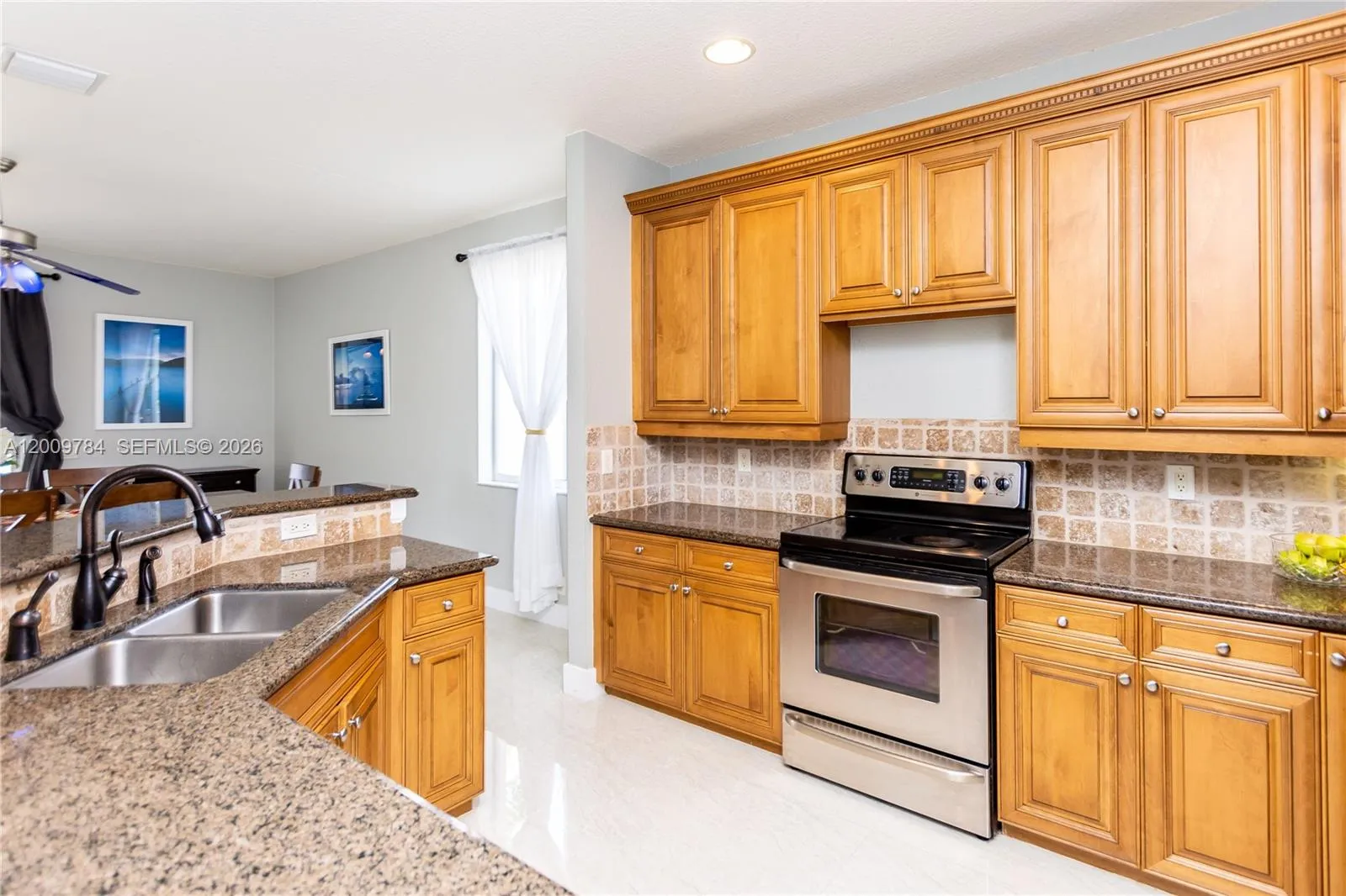 Bright kitchen with wood cabinets, granite and stainless steal appliances