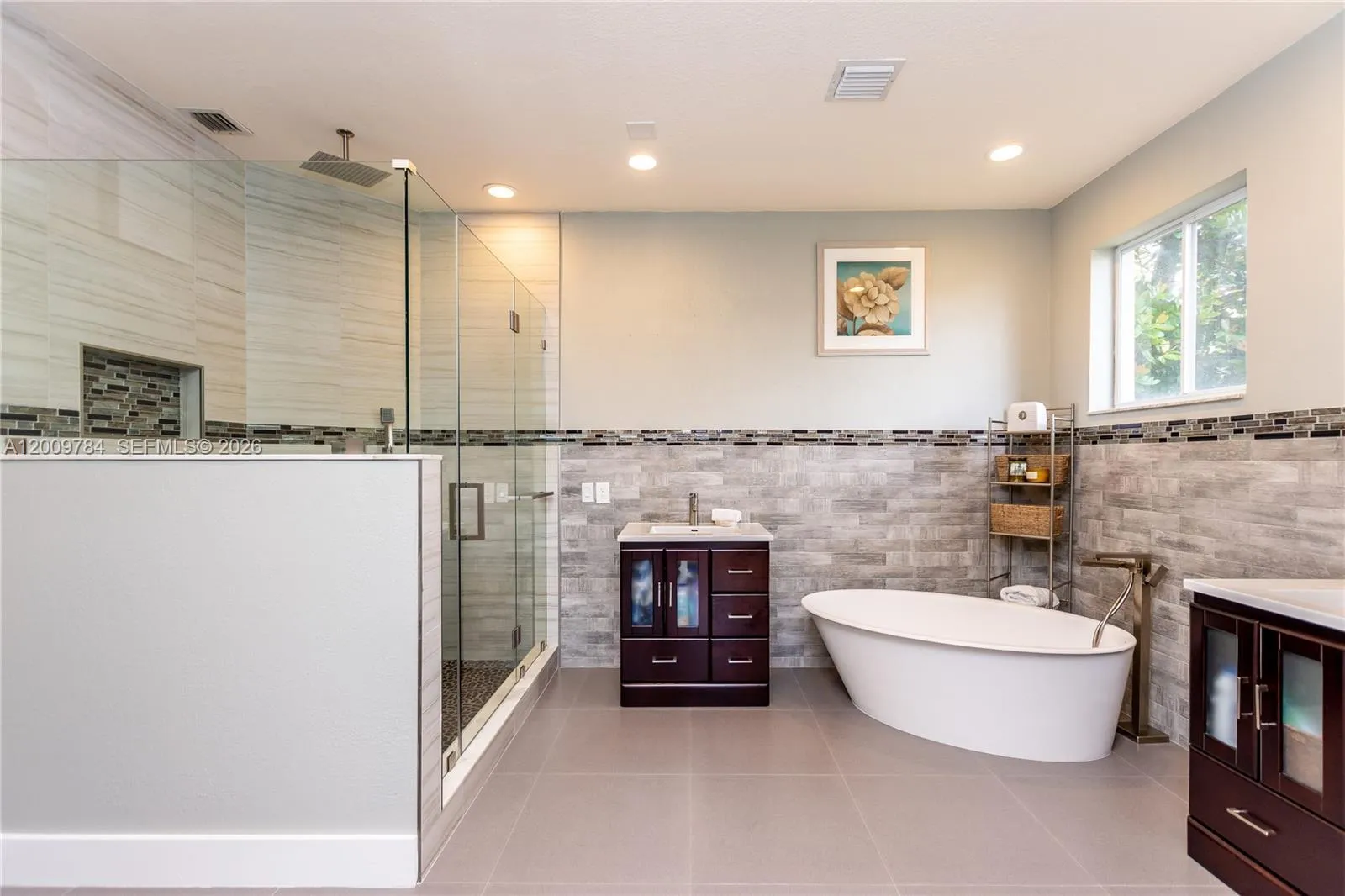 Amazing 1st floor master bathroom with free standing tub, his and hers vanities, rain shower, Italian brass nickel accessories.