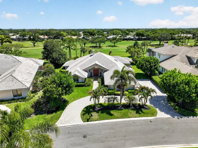 Front with driveway and golf course