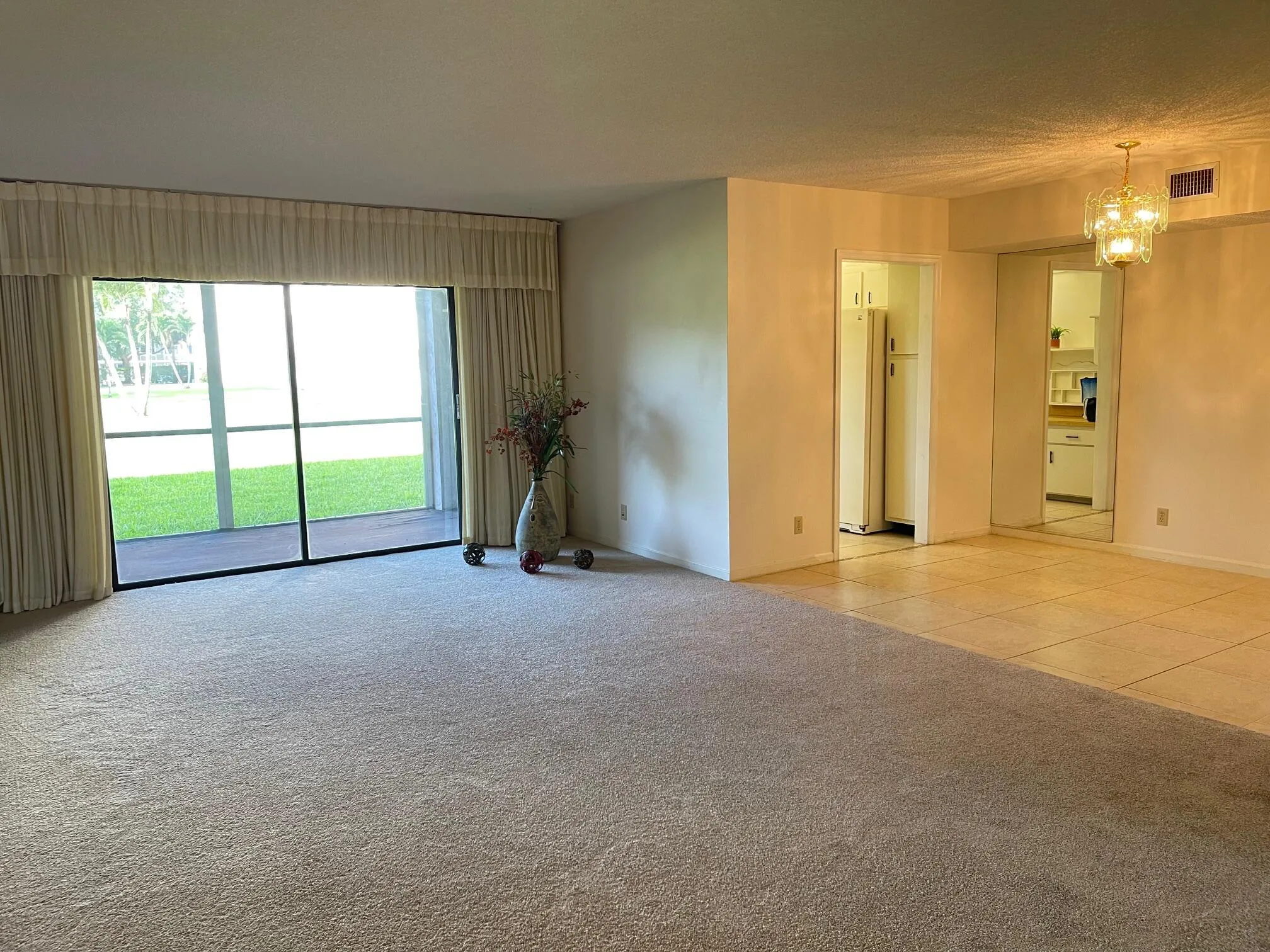 LIVING ROOM OPENS TO THE TILED DINING AREA