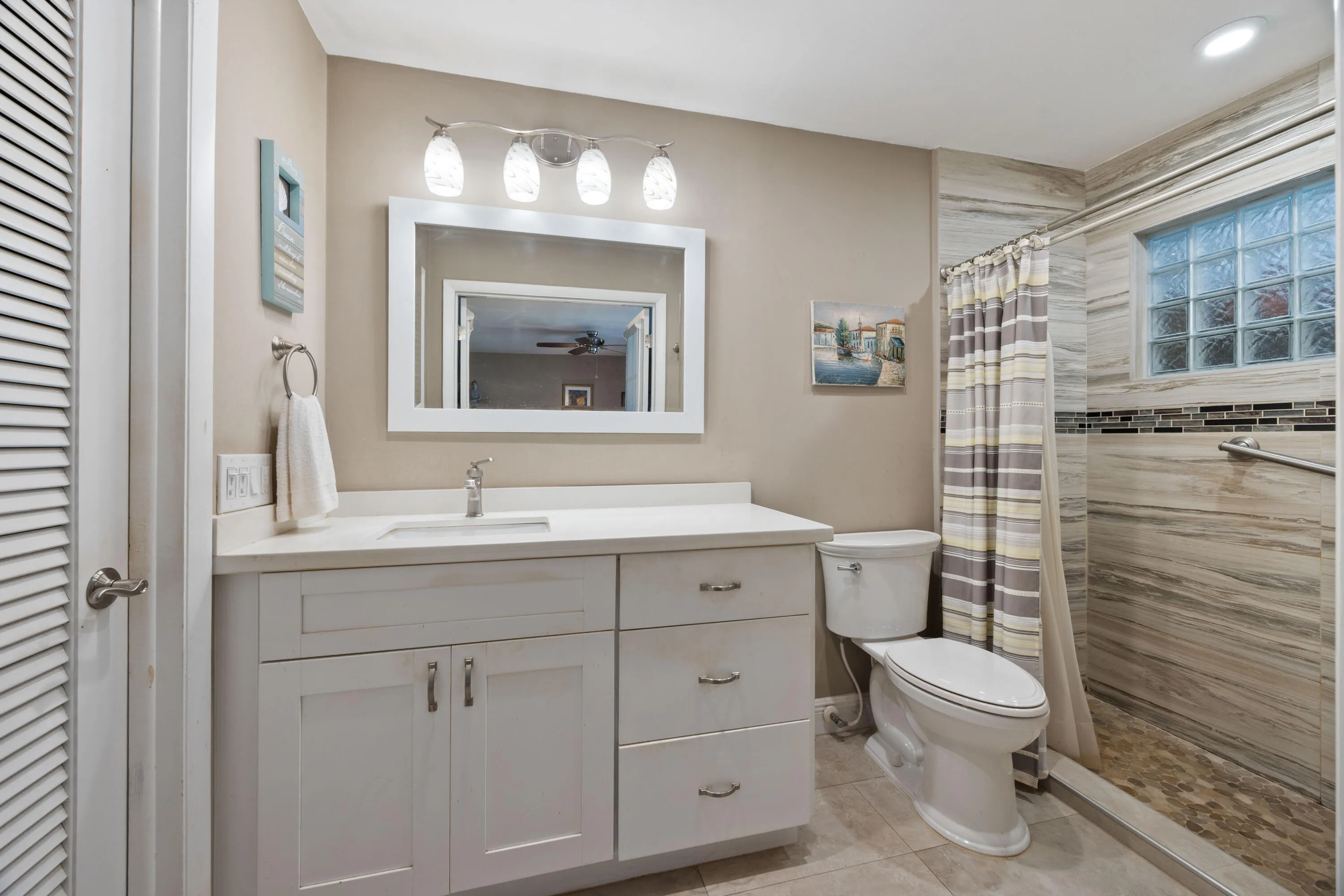 Updated bathroom with shaker style vanity and shore enclosure