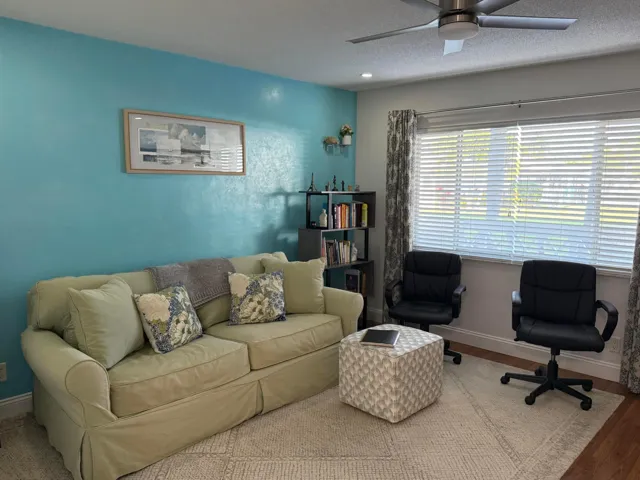 Entry and living room with view of the garden & pool area
