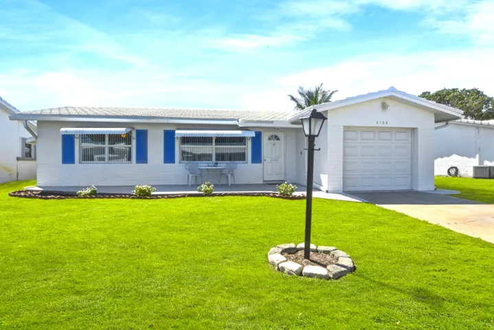 Edgewood Model with concrete driveway and front porch.