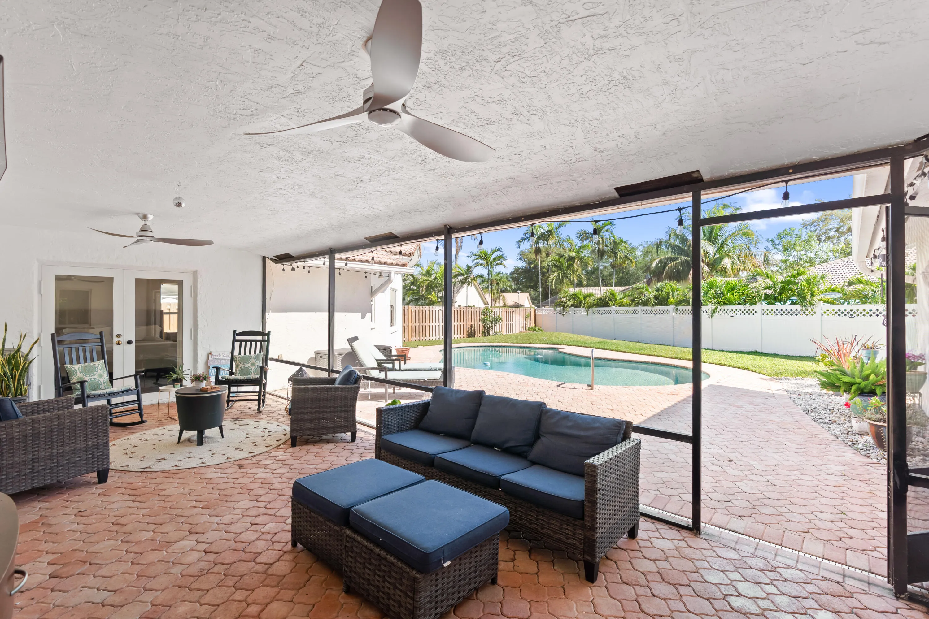 Covered and screened-in patio with brick pavers