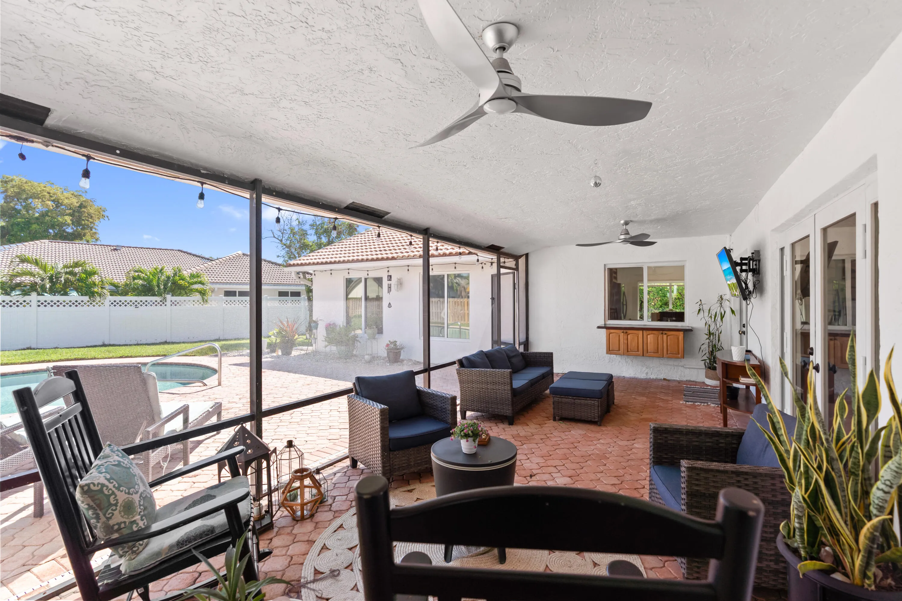 Covered and screened-in patio with brick pavers
