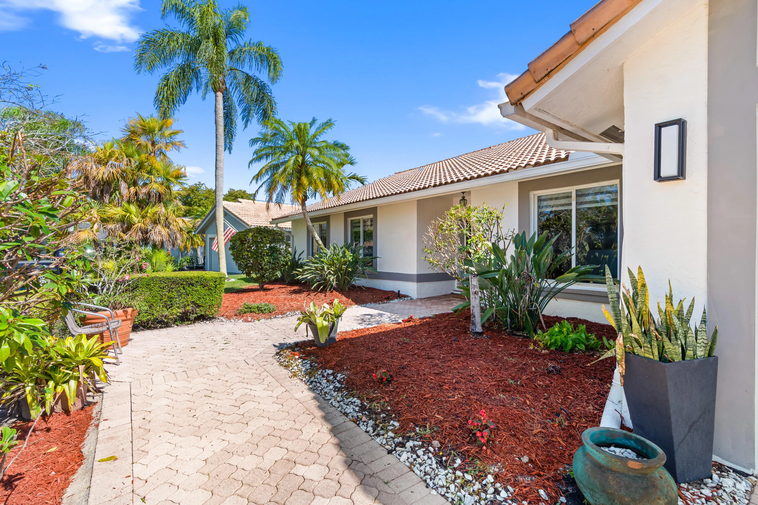 Brick paver entryway and driveway and mature landscaping