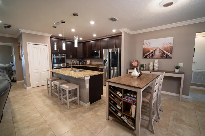 Open chef’s kitchen with granite, stainless appliances, and a large island.