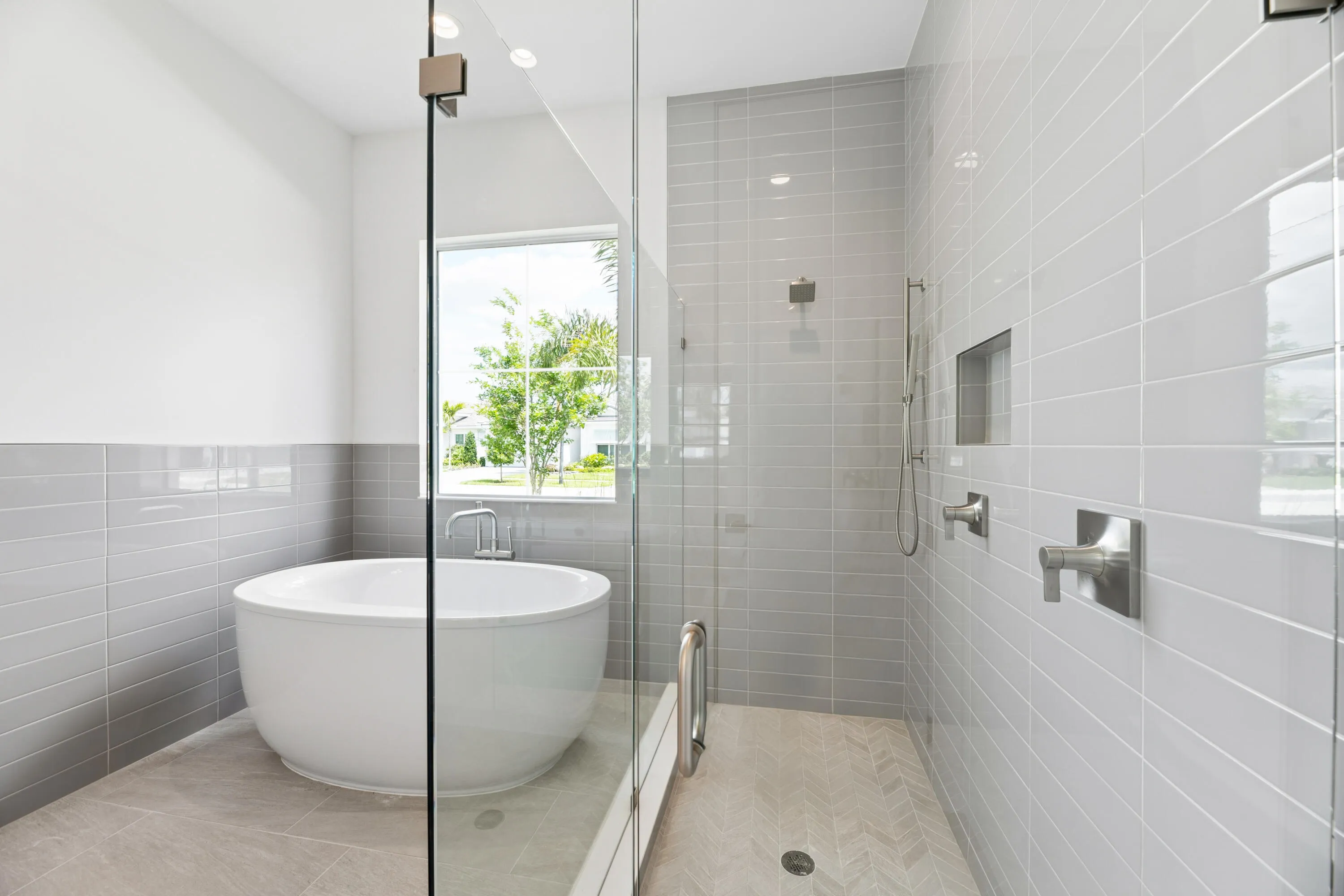 luxurious bathroom featuring a freestanding soaking tub and a separate glass-enclosed walk-in shower