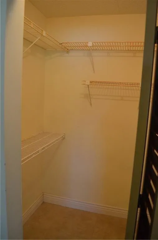 Primary bedroom walk in closet