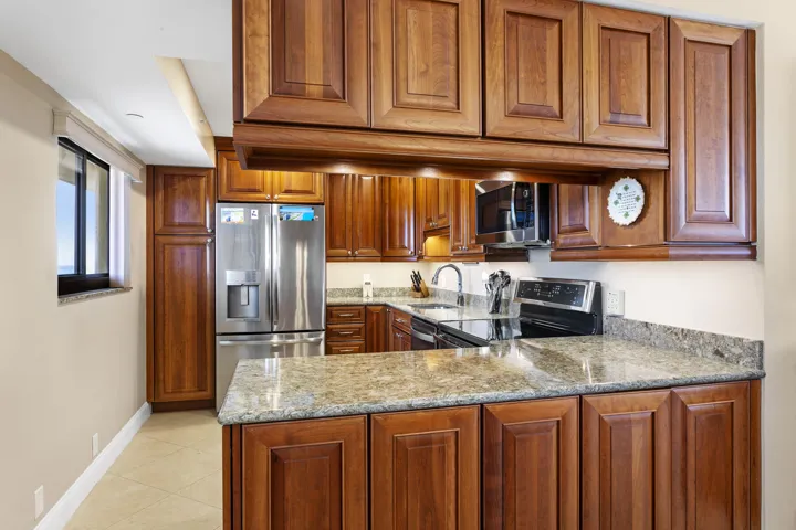 Open Kitchen with Solid Wood Cabinets and Stone Countertops