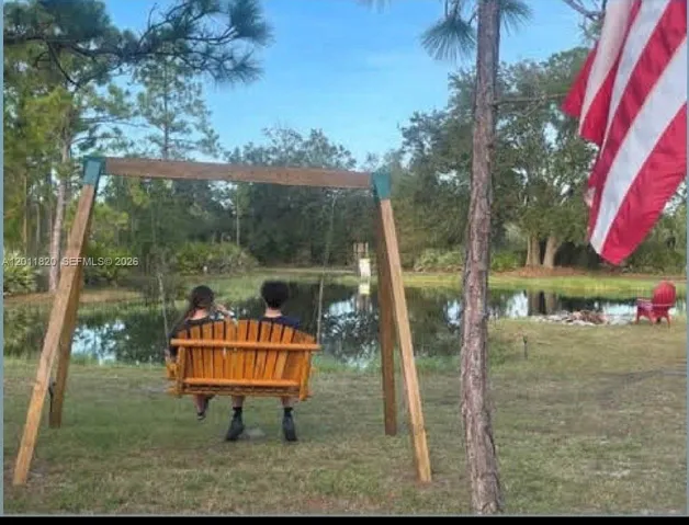 outdoor wooden swing overlooking pond