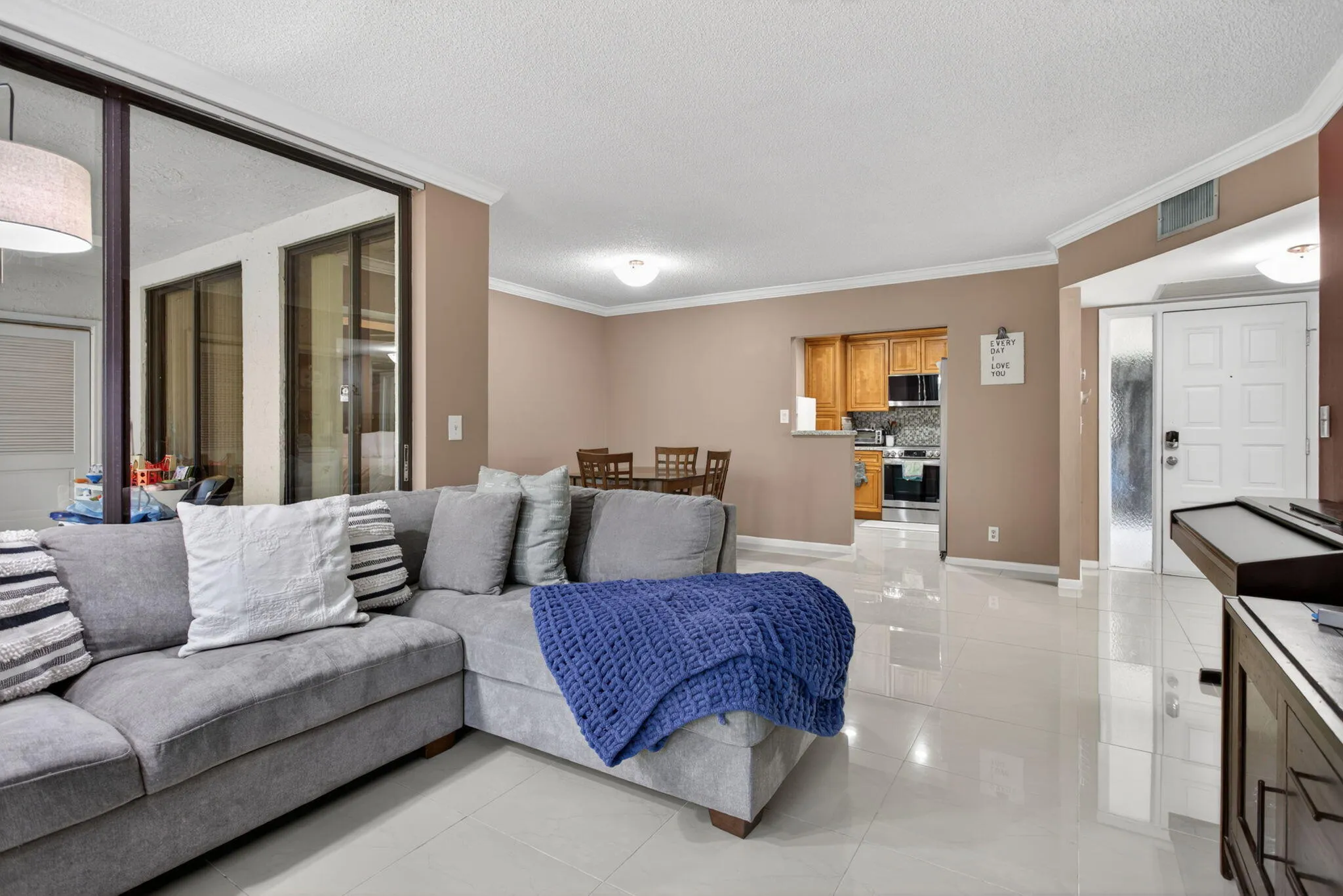 The unit has a lot of natural light from the floor to ceiling impacted windows. The unit has beautiful porcelain tile that runs throughout the living, dining and kitchen.