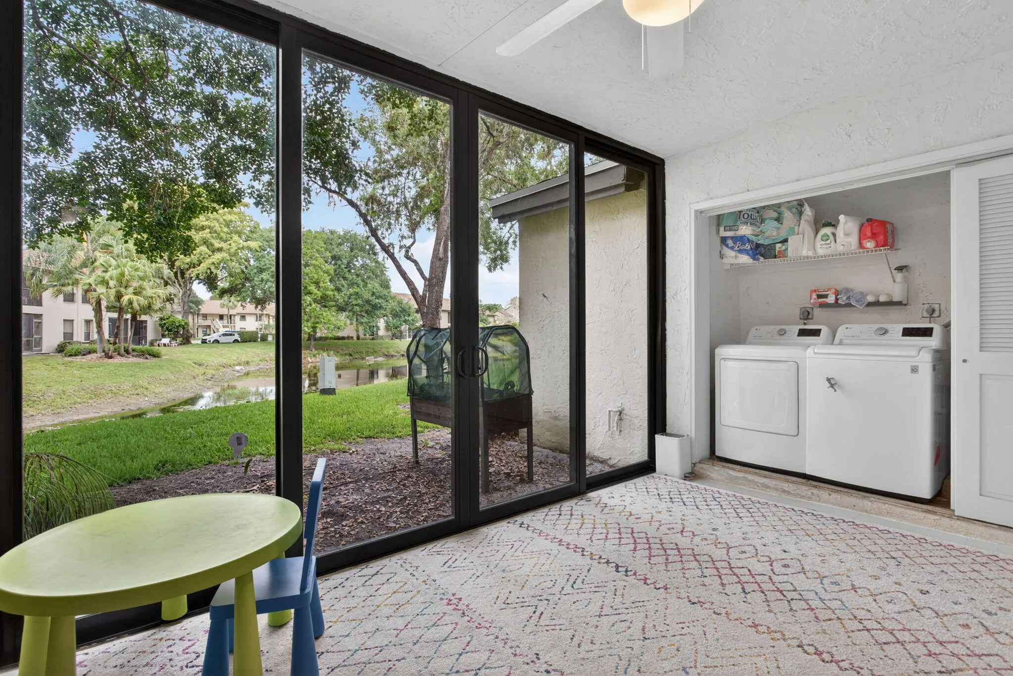 This incredible outdoor patio area features a washer and dryer, floor to ceiling impact windows overlooking a waterfront view of the canal.