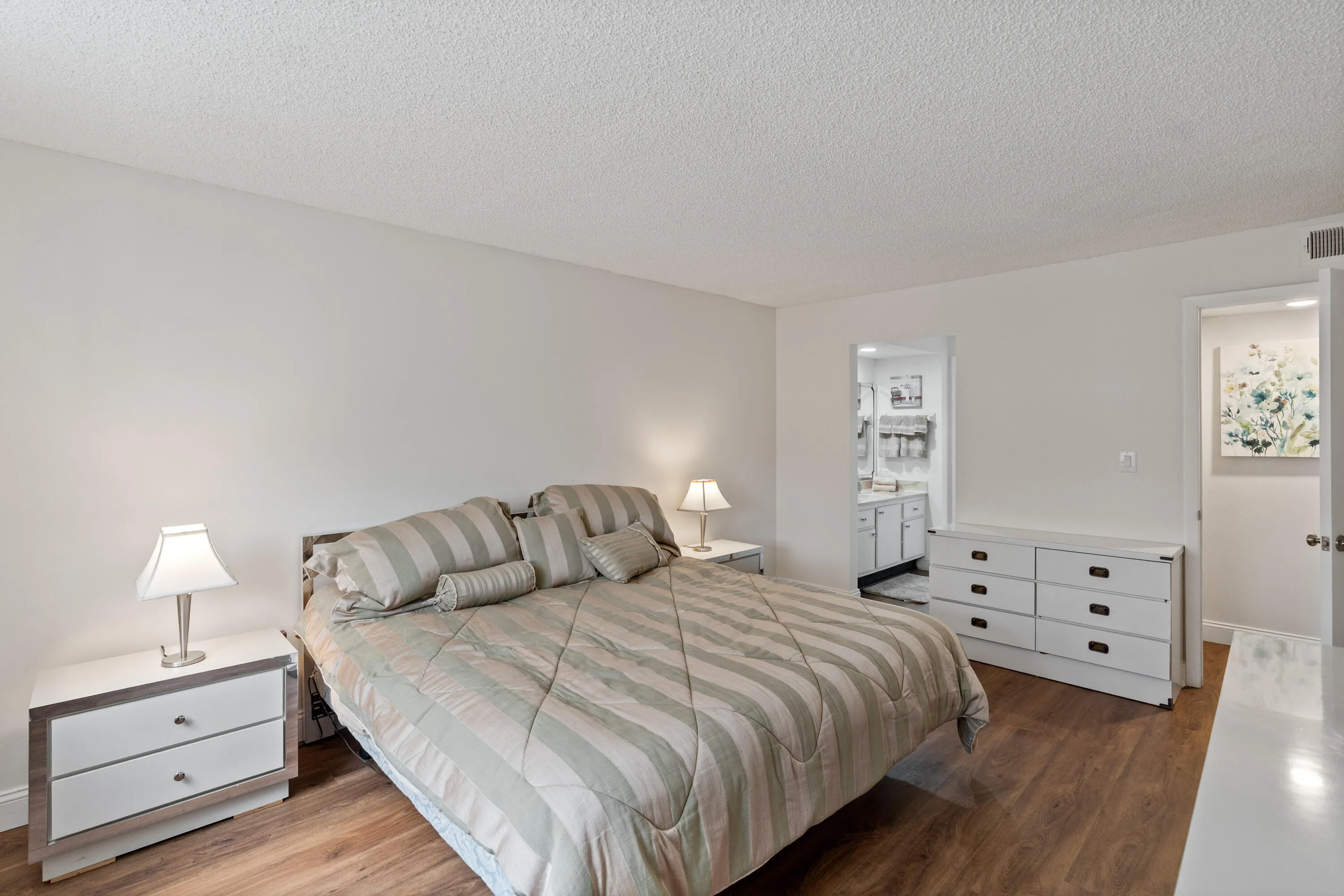 Master bedroom with sink area of master bathroom.